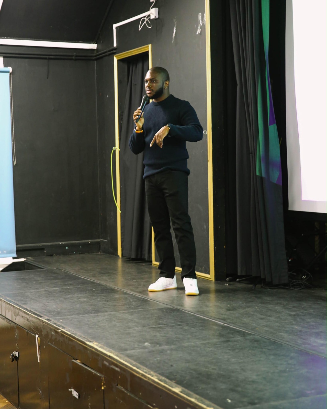 Rume Dominic speaking on stage